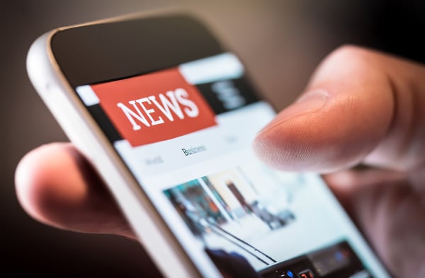 Closeup of person scrolling news on phone