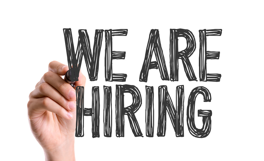Hand with marker writing We Are Hiring Hand with marker writing We Are Hiring