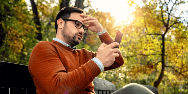 Man looking upset at his smartphone