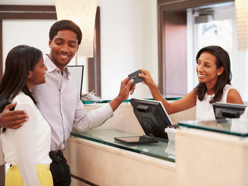 Couple on Vacation at a Receptionist's Desk