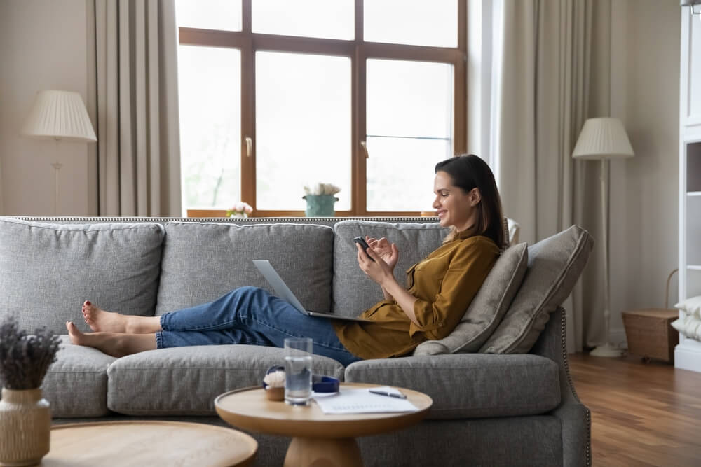 Interested customer browsing online using a smartphone and computer.