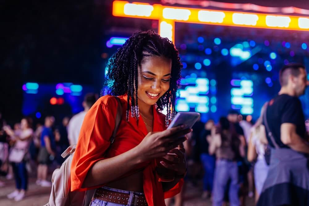 Woman checking social media at music event